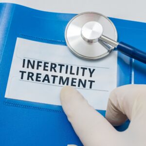 Infertility treatment blue folder with stethoscope.