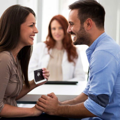 Happy couple with ultrasound photo | Arizona Reproductive Medicine Specialists
