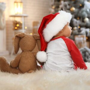 Baby in Santa hat with teddy bear | Arizona Reproductive Medical Specialists