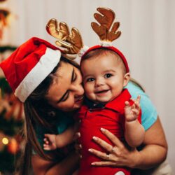 Mom in Santa hat with IVF baby wearing antlers | Arizona Reproductive Medical Specialists