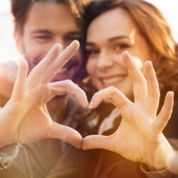 Closeup of couple making heart shape with hands | Arizona Reproductive Medicine Specialists | Phoenix